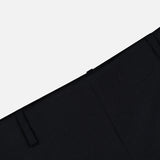 Close-up of the KHAITE Grenare Straight Leg Pant in black wool, laid flat on a light gray background. The image highlights the waistband, belt loop, and upper pant leg of these expertly crafted Italian trousers, designed for a refined and timeless tailored fit.