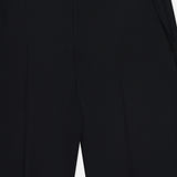 Close-up view of the KHAITE Grenare Straight Leg Pant, highlighting the tailored waistband, belt loops, and side pockets. The black wool trousers are neatly pressed with defined crease lines down the front.