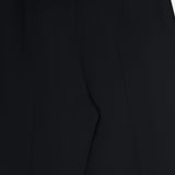 Close-up of the KHAITE Grenare Straight Leg Pant in black wool, focusing on the upper part with belt loops and leg seams against a white background. These tailored-fit trousers are expertly crafted in Italy, showcasing refined craftsmanship and meticulous attention to detail.