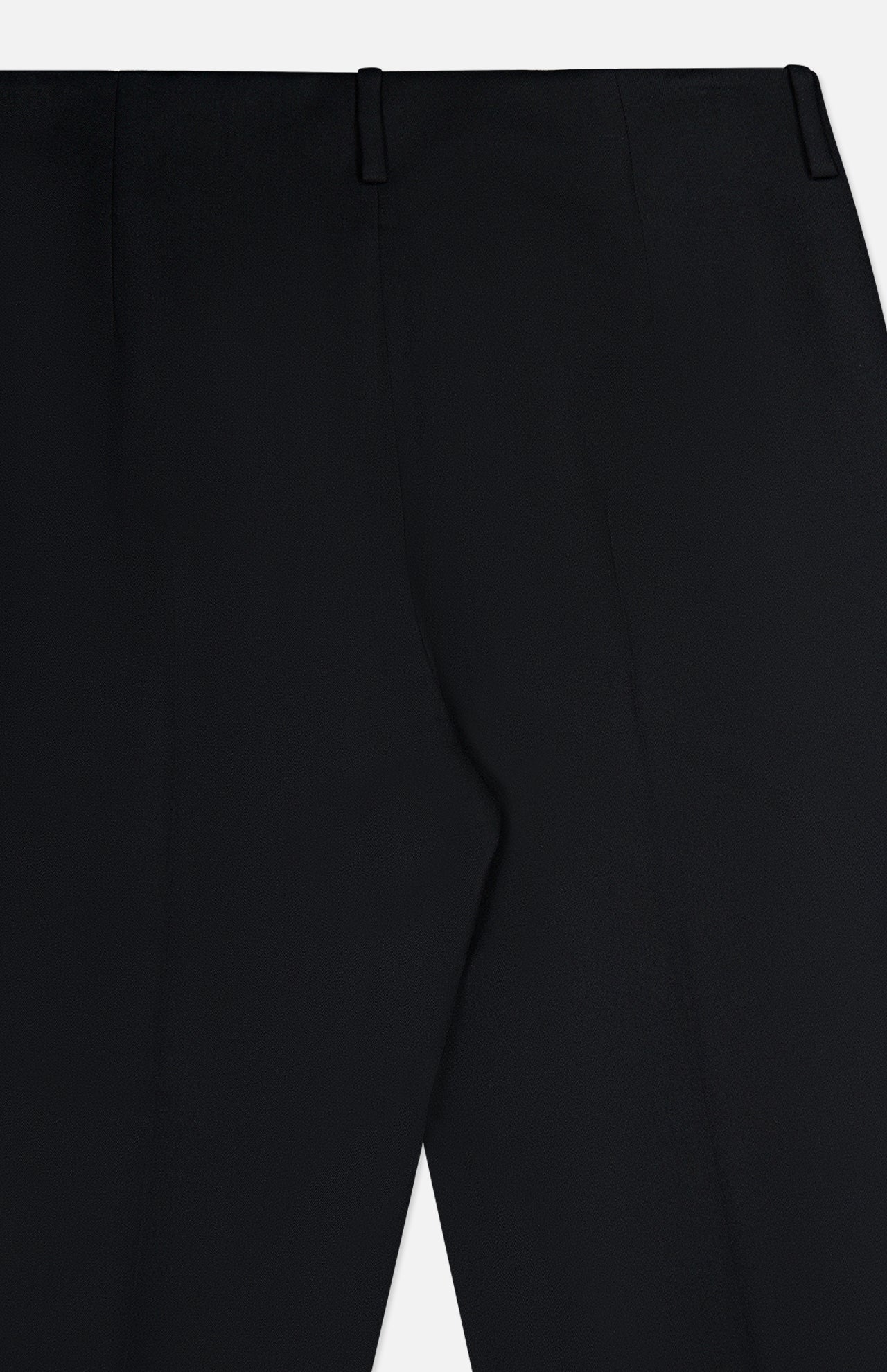 Close-up of the KHAITE Grenare Straight Leg Pant in black wool, focusing on the upper part with belt loops and leg seams against a white background. These tailored-fit trousers are expertly crafted in Italy, showcasing refined craftsmanship and meticulous attention to detail.