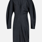 Back view of the KHAITE Harlin Draped Midi Dress in dark grey Italian wool-cashmere, featuring long sleeves with buttoned cuffs, a high collar, and an asymmetric hem—a refined choice for the minimalist wardrobe—displayed against a plain white background.