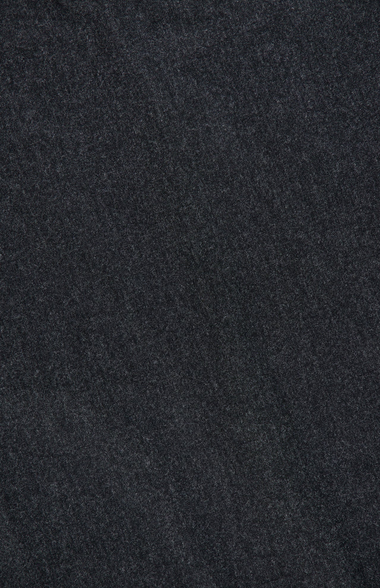 A close-up image of a dark, smooth surface, subtly textured with fine natural lines, evokes the timeless elegance of the Harlin Draped Midi Dress by KHAITE in a rich charcoal hue.