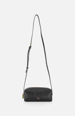 The KHAITE Kye Mini Crossbody Bag in black patent leather features a long adjustable strap, gold-tone hardware, and a small padlock detail, shown against a plain white background.