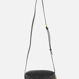 The KHAITE Kye Mini Crossbody Bag in black patent leather features a long adjustable strap and gold-tone hardware, shown upright against a plain white background.