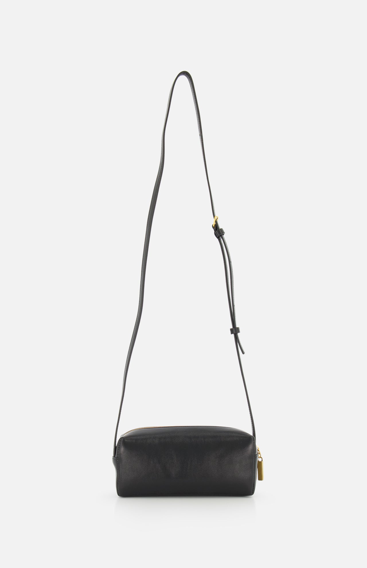 The KHAITE Kye Mini Crossbody Bag in black patent leather features a long adjustable strap and gold-tone hardware, shown upright against a plain white background.