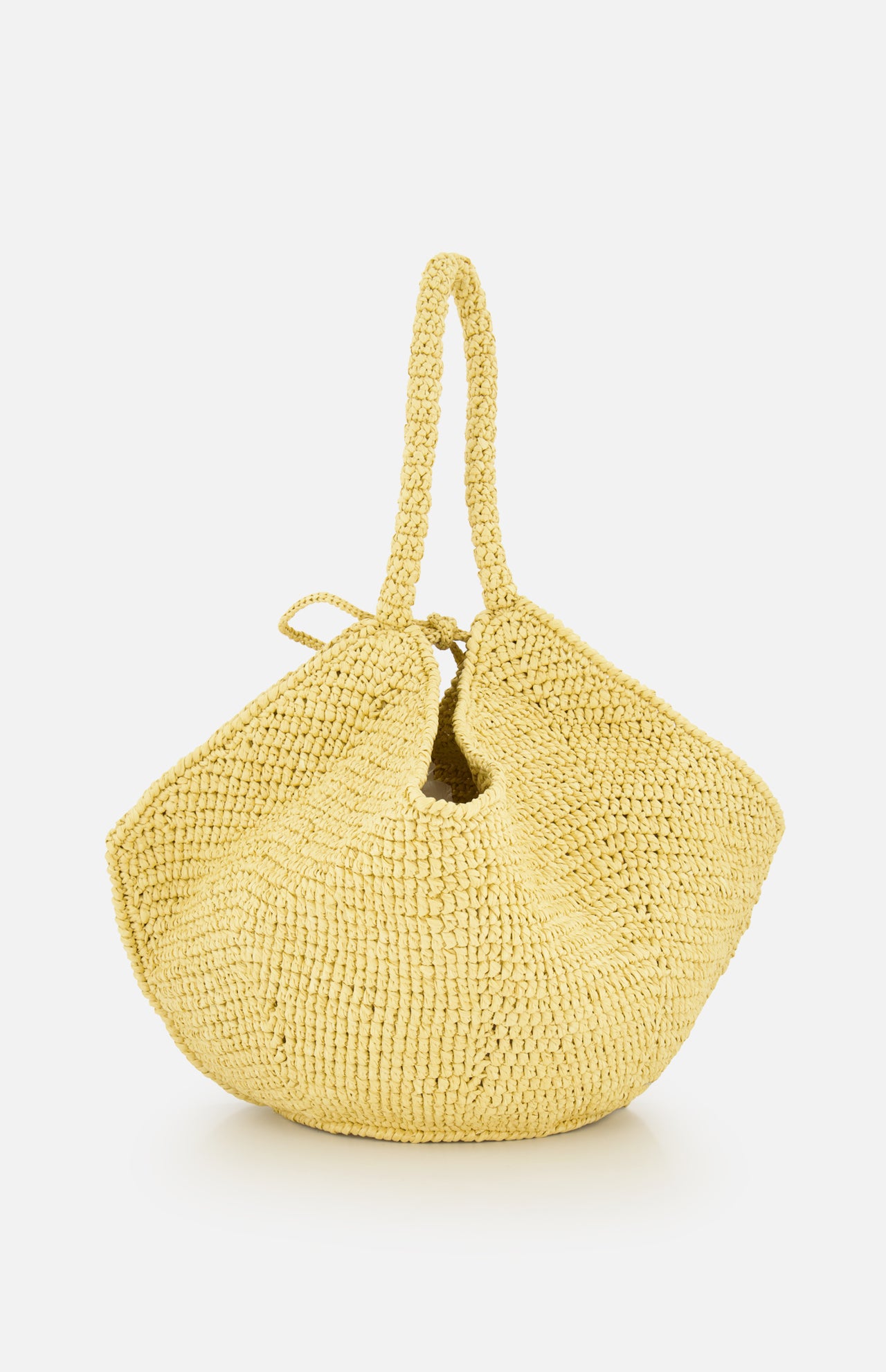The Lotus Viscose Raffia Medium Bag by KHAITE is a yellow tote crafted from sustainably harvested raffia, featuring a slouchy, rounded silhouette and two handles, shown against a plain white background.
