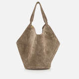 The KHAITE Lotus Medium Suede Tote Bag features a slouchy, geometric silhouette in lightweight taupe suede with a single wide shoulder strap, minimal gold hardware, removable pouch, and a subtle logo near the bottom.