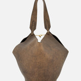 KHAITE’s Lotus Small Tote Bag—a brown, textured distressed leather tote with a wide, curved silhouette, two sturdy handles, and a subtle gold chain clasp at the center opening—is thoughtfully crafted in Italy for the minimalist wardrobe and showcased on a plain white background.