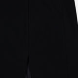 Close-up of the KHAITE Lyle Column Skirt, crafted in Italy in black with a center slit and small black button closure. Its smooth, tailored fabric and clean seams make it ideal for a minimalist wardrobe.