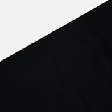 A minimalist image with a diagonal split between light gray above and black below, featuring a subtle vertical seam—evoking the chic Lyle Column Skirt by KHAITE, crafted in Italy.