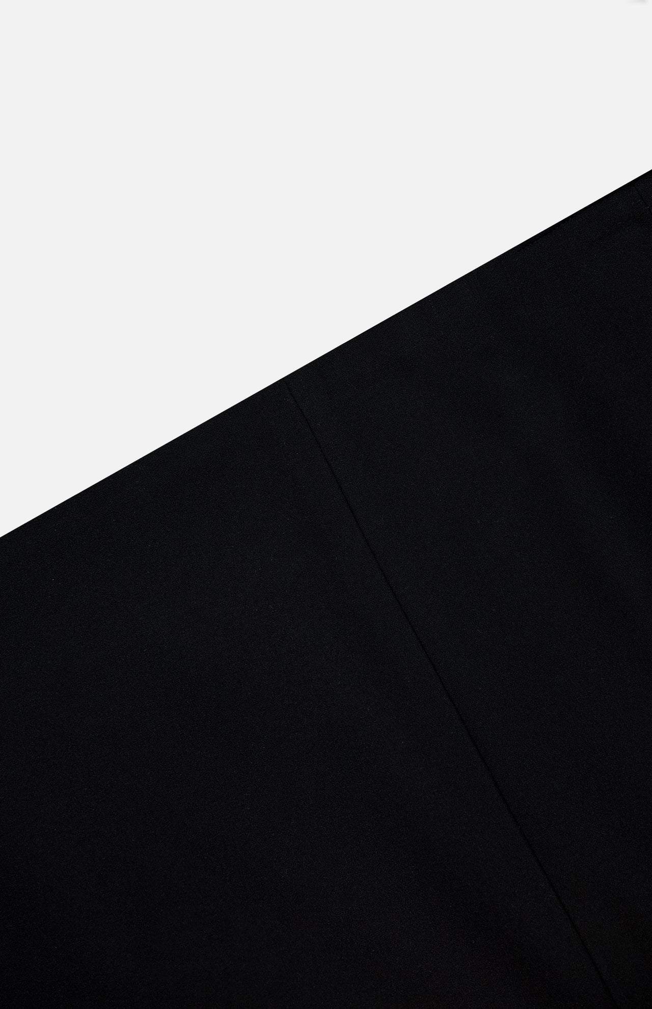 A minimalist image with a diagonal split between light gray above and black below, featuring a subtle vertical seam—evoking the chic Lyle Column Skirt by KHAITE, crafted in Italy.