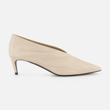The KHAITE Miriam Glazed Leather Pump 50 is a nude pointed-toe heel with a low profile and smooth finish, perfect for minimalist looks, shown side-on against a plain white background.