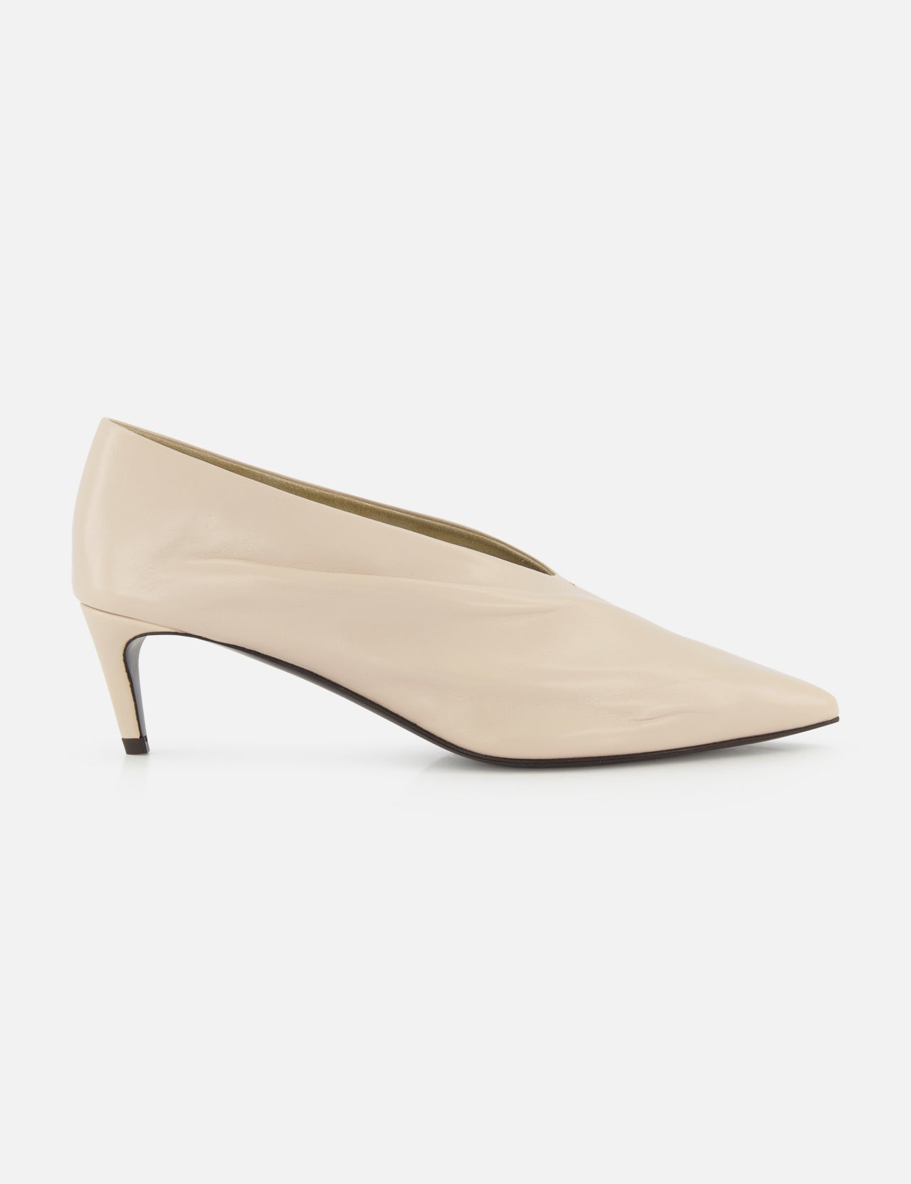 The KHAITE Miriam Glazed Leather Pump 50 is a nude pointed-toe heel with a low profile and smooth finish, perfect for minimalist looks, shown side-on against a plain white background.
