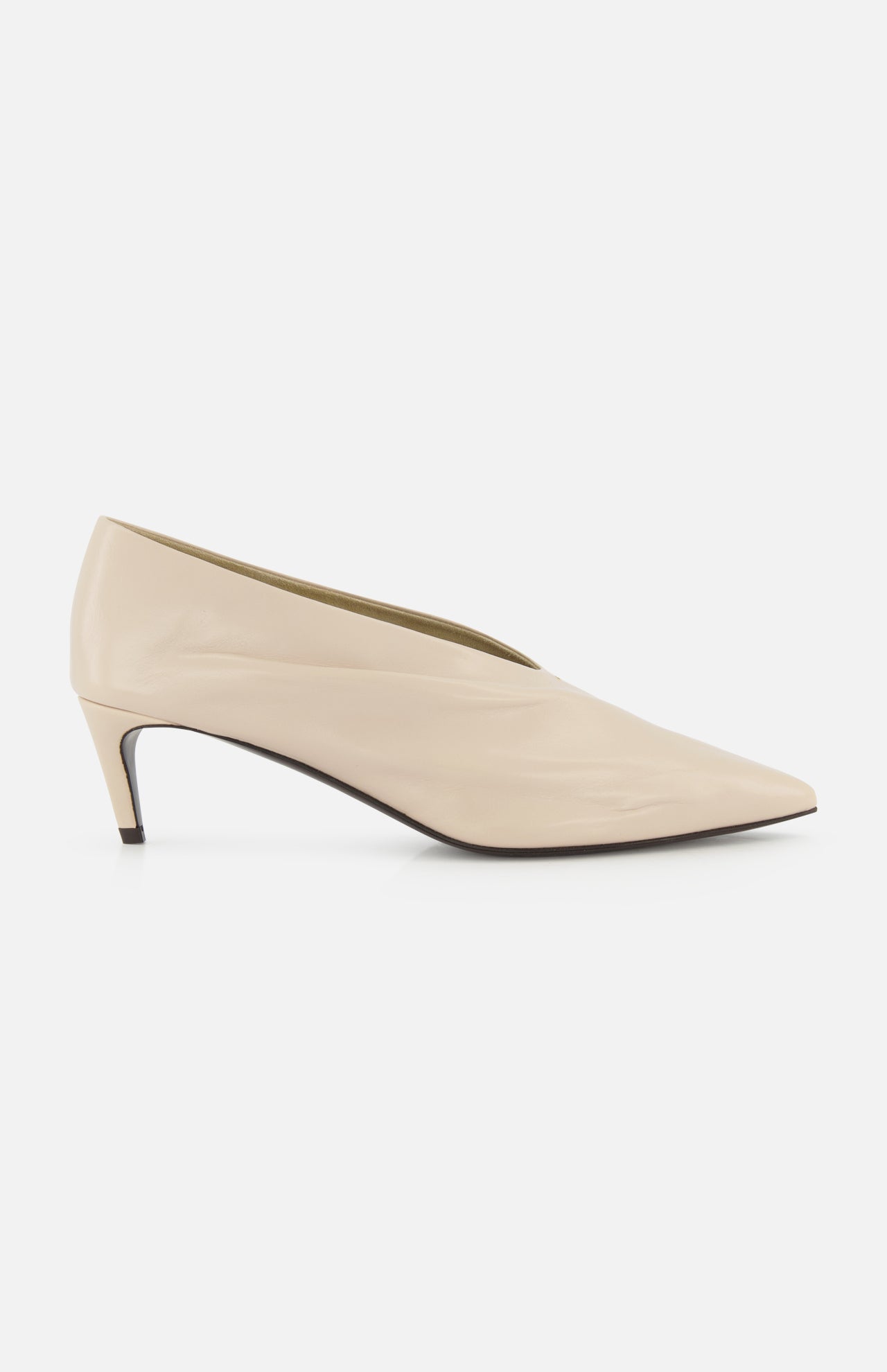 The KHAITE Miriam Glazed Leather Pump 50 is a nude pointed-toe heel with a low profile and smooth finish, perfect for minimalist looks, shown side-on against a plain white background.