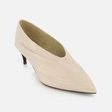 The KHAITE Miriam Glazed Leather Pump 50 features nude glazed leather, a pointed toe, and a low heel with a smooth finish—ideal for minimalist wardrobes and shown on a white background.