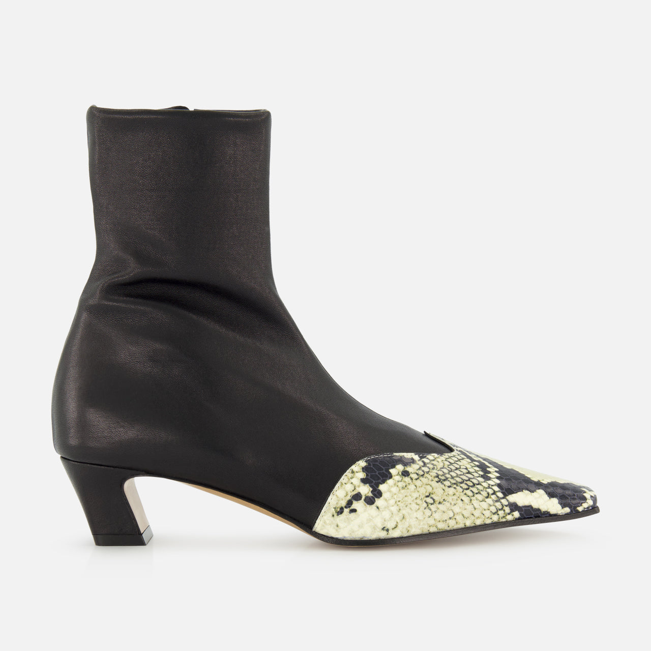The KHAITE Nevada Ankle Stretch Boot in Python is a sleek black mid-calf boot with a low heel and pointed toe, highlighted by a contrasting light snakeskin pattern for added style.