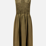 The KHAITE Nola Smocked Waist Dress is a sleeveless dark olive dress with a V-neckline, a ruched bodice featuring a hand-smocked waist with intricate detailing, and a flared, knee-length skirt crafted from lightweight, subtly lustrous fabric.