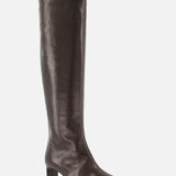 The Ona Knee High Boot by KHAITE is a tall, dark brown leather boot featuring a square toe and a low block heel, expertly crafted in Italy and displayed against a plain white background.