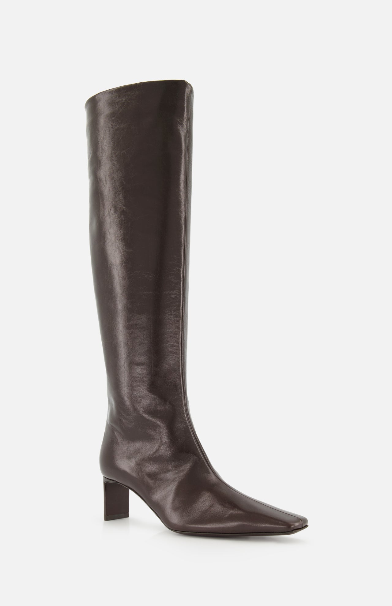 The Ona Knee High Boot by KHAITE is a tall, dark brown leather boot featuring a square toe and a low block heel, expertly crafted in Italy and displayed against a plain white background.