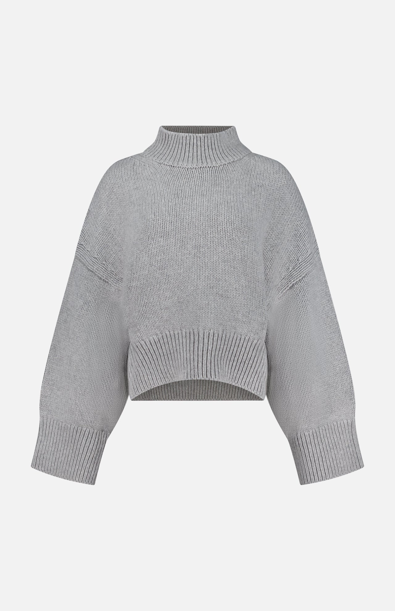The Phelps Cashmere Sweater by KHAITE—a light gray, long-sleeve cropped knit—features a ribbed mock neck, cuffs, and hem, making it an ideal choice for a minimalist wardrobe. Displayed against a plain white background.
