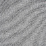 Close-up of the light gray textured fabric of the KHAITE Phelps Cashmere Sweater, featuring diagonal ribbed lines that form a pattern of small, evenly spaced ridges—an elegant detail that adds understated appeal to any minimalist wardrobe.