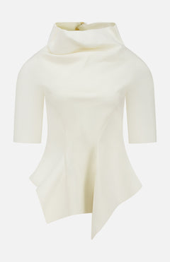 The Pippa Peplum Top by KHAITE features a cream Italian wool suiting with a draped funnel neckline and asymmetrical sculpted hemline, set against a plain background.