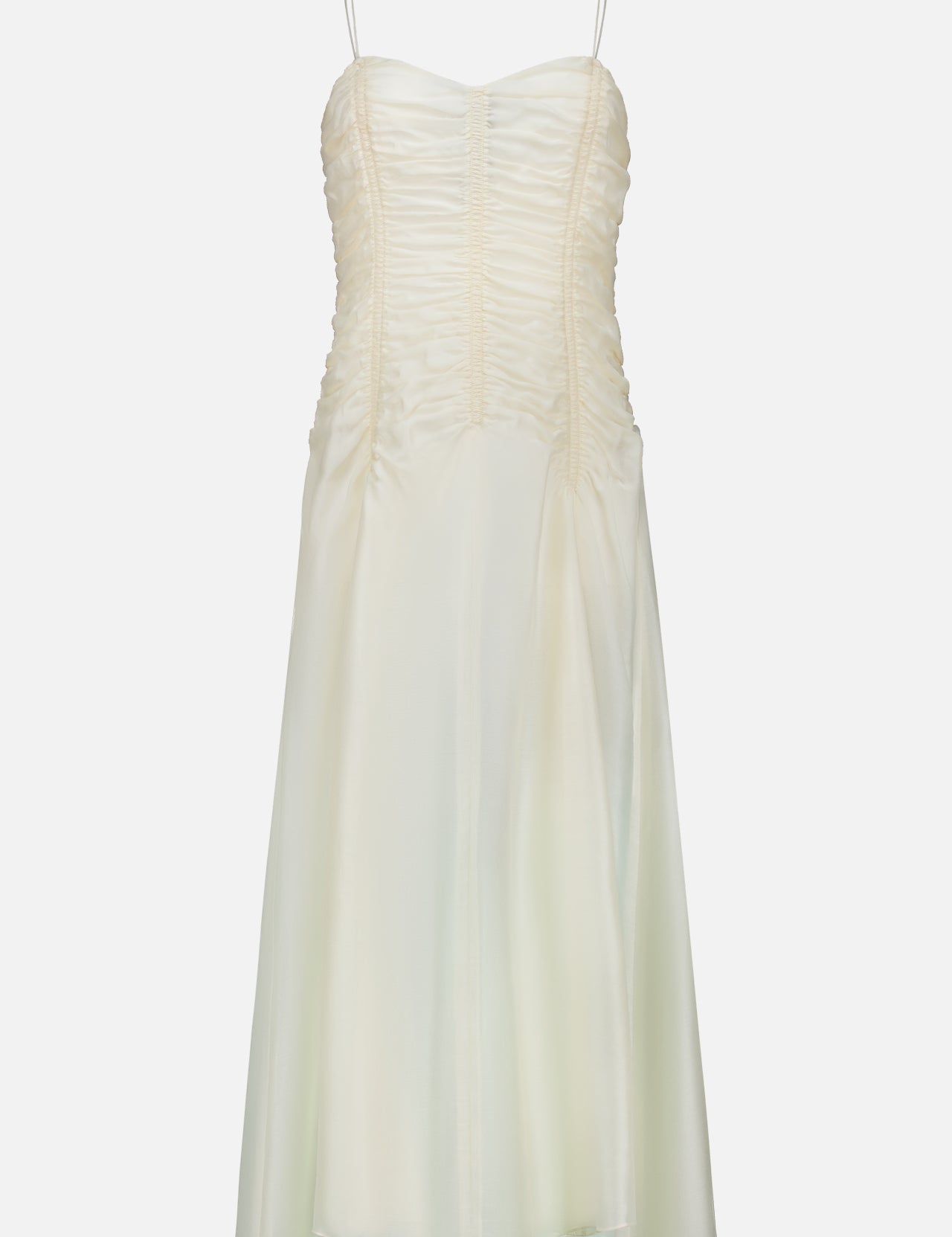The Raina Ruched Midi Dress by KHAITE is an ivory silk charmeuse dress featuring a sleeveless silhouette, delicate spaghetti straps, and ruched detailing on the bodice. This midi dress flares gently with a subtle sheer finish and is photographed against a plain white background.