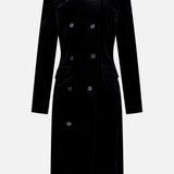 The Rolon Velvet Coat by KHAITE is a long black cotton velvet coat featuring a double-breasted design with six buttons, a stand collar, and long sleeves—an elegant staple for any minimalist wardrobe—shown against a plain white background.