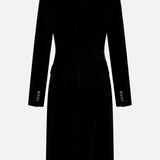 The Rolon Velvet Coat by KHAITE is a black, long-sleeved, tailored-fit coat crafted from cotton velvet, featuring refined button detailing on the cuffs and a straight back—an elegant choice for any minimalist wardrobe. Shown against a plain white background.