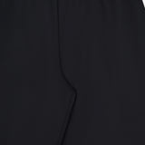Close-up of the KHAITE Roma Cropped Pull-on Pant in black, featuring an elastic waistband and smooth, pattern-free lightweight wool suiting for comfort and style.