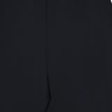 Close-up of the KHAITE Roma Cropped Pull-on Pant, showcasing its black lightweight wool suiting, elastic waistband, smooth texture, and minimal design. Image is cropped to highlight only the upper section of the pants.