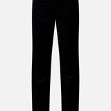 The Ryden Velvet Pant by KHAITE features a straight-leg cut in black velvet, displayed against a plain white background. These high-rise pants offer a smooth texture with no visible buttons or zippers, resulting in a tailored and elegant appearance.