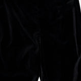 Close-up of the KHAITE Ryden Velvet Pant in black, highlighting the upper front section with its defined waistband and seam details. This high-rise style showcases a soft, luxurious velvet texture with a subtle sheen, expertly crafted in Italy.