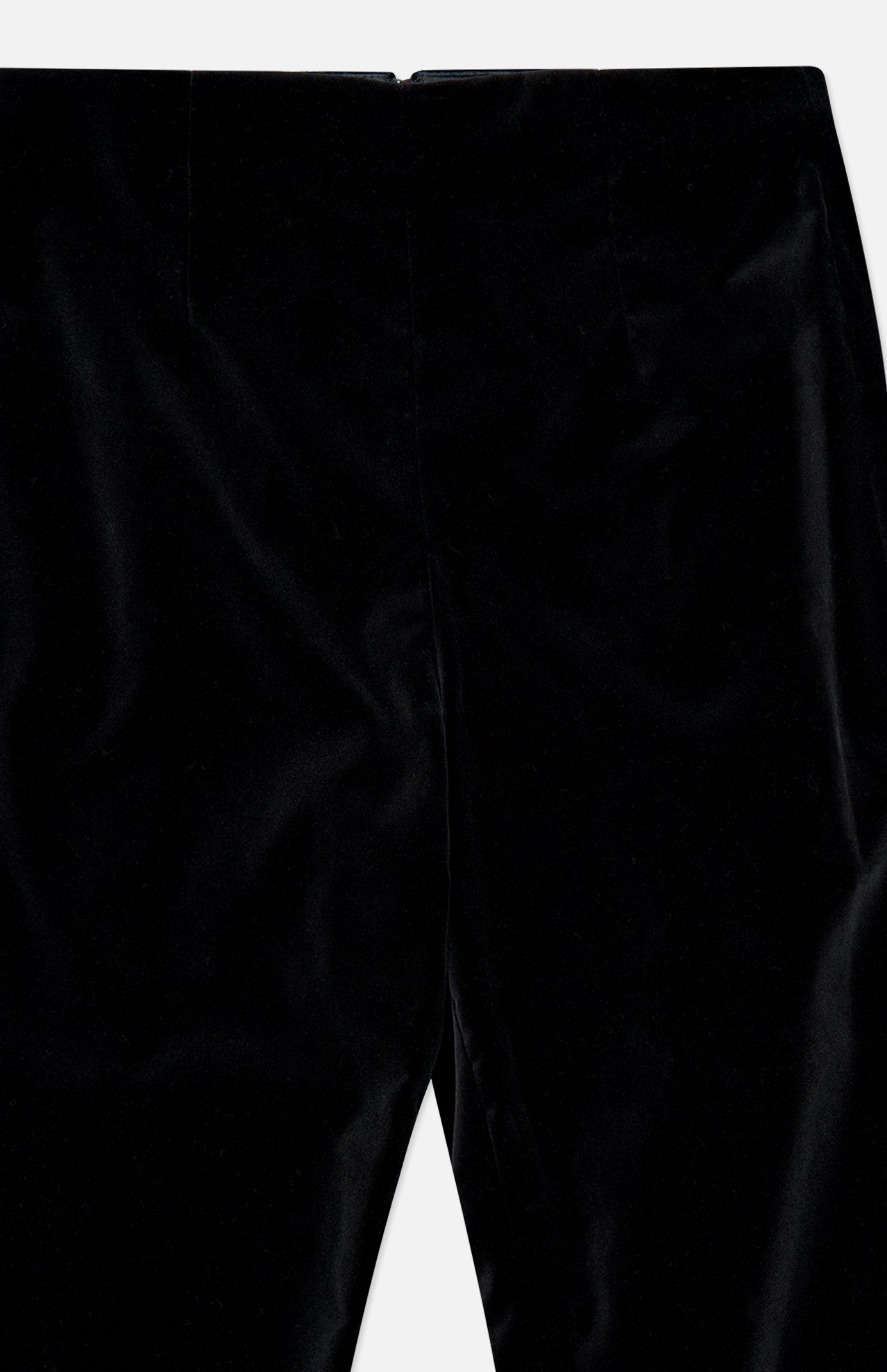 Close-up of the KHAITE Ryden Velvet Pant in black, highlighting the upper front section with its defined waistband and seam details. This high-rise style showcases a soft, luxurious velvet texture with a subtle sheen, expertly crafted in Italy.