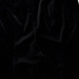 Close-up of the KHAITE Ryden Velvet Pant in black, made in Italy, highlighting the front seam detail and the luxurious, smooth texture of its velvet fabric.