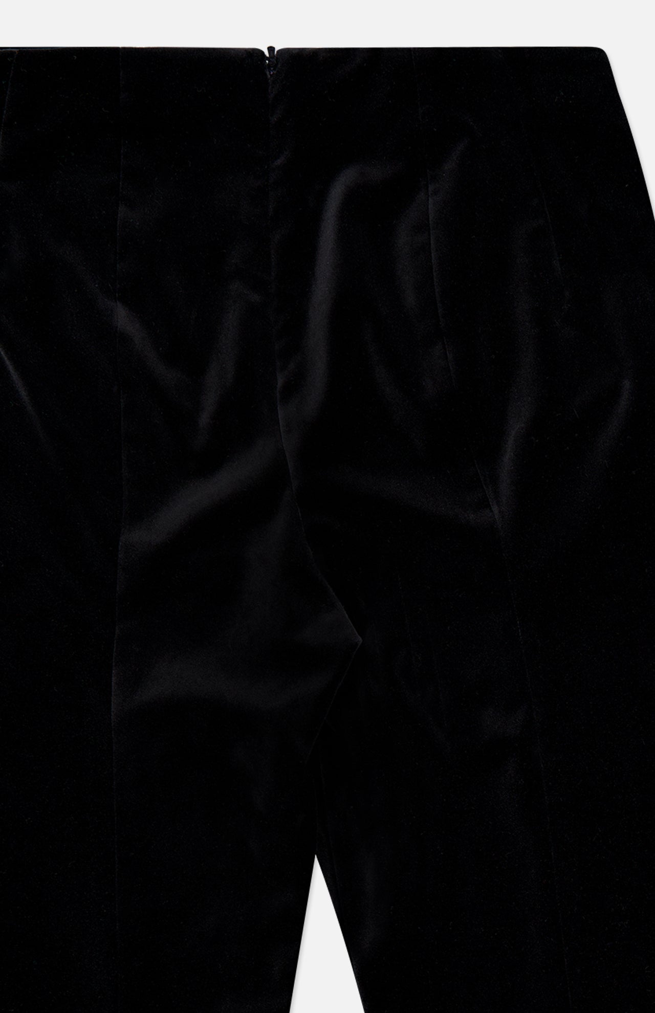 Close-up of the KHAITE Ryden Velvet Pant in black, made in Italy, highlighting the front seam detail and the luxurious, smooth texture of its velvet fabric.