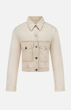The Tomer Collared Cropped Denim Jacket by KHAITE features beige denim, a pointed collar, button-down front, long sleeves, and two chest flap pockets—perfect for a minimalist wardrobe. Shown on a white background.