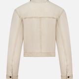 Back view of the KHAITE Tomer Collared Cropped Denim Jacket in beige, featuring long sleeves, a collar, buttoned cuffs, and seam detailing—an ideal minimalist piece—displayed against a plain white background.