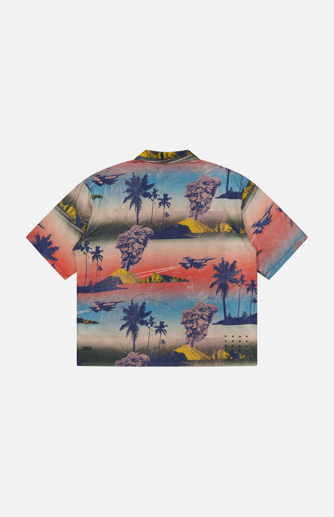 The KSUBI Mauna Loa Short Sleeve Diner Shirt features an oversized fit, vibrant tropical print with palm trees and mountains in blue, pink, yellow, and orange on a light background. Shown laid flat from the back.