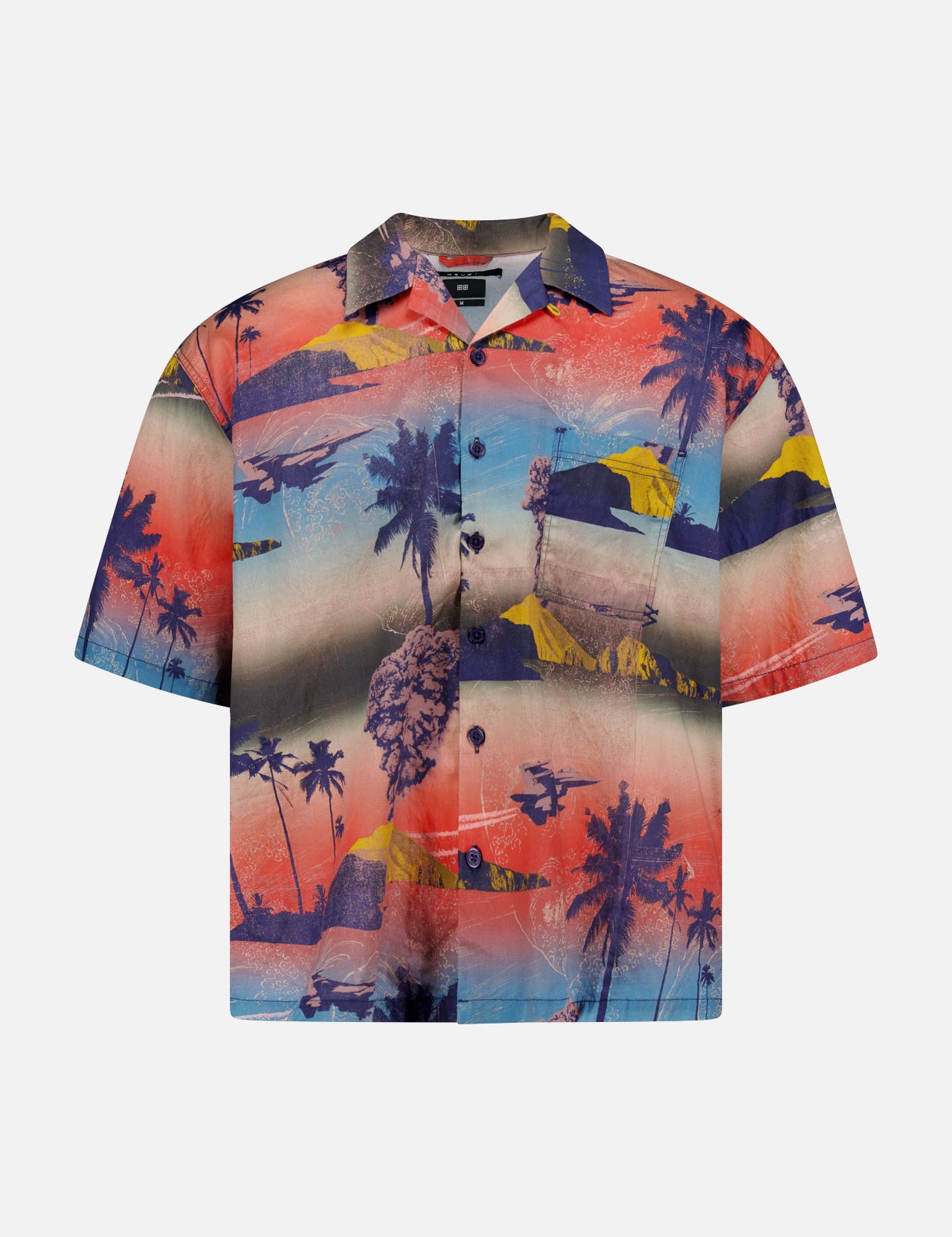 The KSUBI Mauna Loa Short Sleeve Diner Shirt is an oversized cotton modal shirt with a vivid tropical print of palm trees, mountains, and oceans in bold red, blue, yellow, and purple hues.