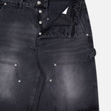 KSUBI Maxx Operator Jean Shorts in black denim with a faded wash, wide leg fit, large carpenter pockets, silver rivets, belt loops, and an exposed button fly (top button fastened), displayed on a white background.