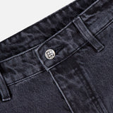 Close-up view of the waistband and button on KSUBI Maxx Operator Jean Shorts, highlighting belt loops, stitched detailing, textured dark black denim, and a glimpse of a carpenter pocket.
