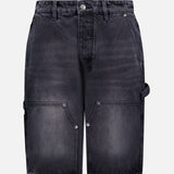 Front view of the KSUBI Maxx Operator Jean Shorts in black denim, featuring wide-leg styling, belt loops, metal button closure, side and carpenter pockets with rivet details.