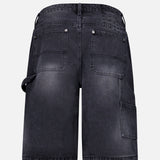 Back view of KSUBI Maxx Operator Jean Shorts in black denim featuring wide legs, two large back pockets, a carpenter pocket, and a left-side hammer loop, shown against a plain white background.