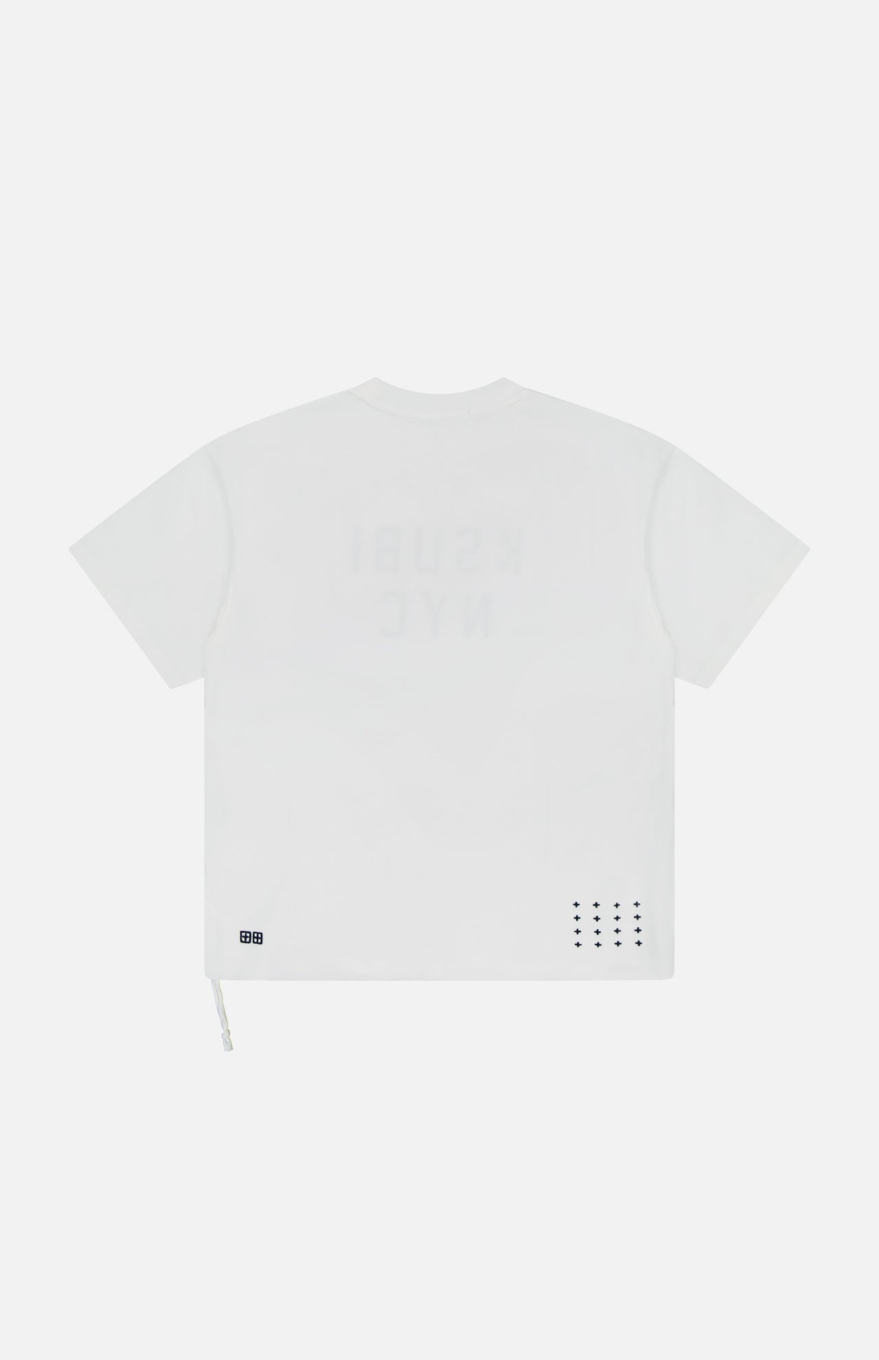 The KSUBI NYC Ekcess Short Sleeve T-shirt is an oversized white tee in premium cotton jersey, featuring a faint NYC logo on the back, small perforated dots, and a square patch near the lower hem.