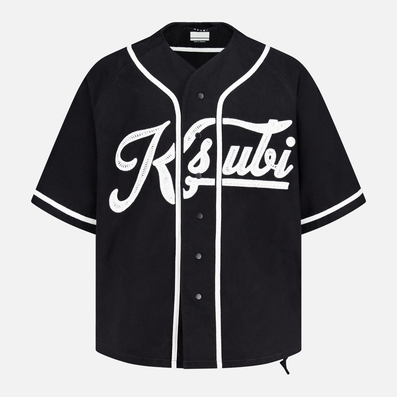 The KSUBI Outfield Short Sleeve Jersey Top is a black oversized-fit jersey featuring white trim, snap buttons, and bold white Ksubi script on the front for a sporty, standout look.