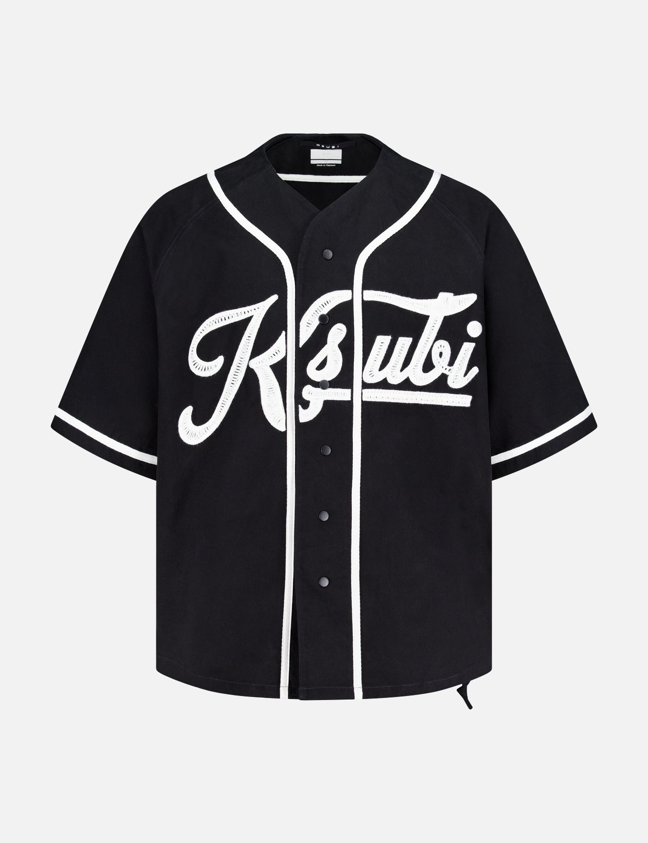 The KSUBI Outfield Short Sleeve Jersey Top is a black oversized-fit jersey featuring white trim, snap buttons, and bold white Ksubi script on the front for a sporty, standout look.