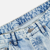 Close-up of the waistband and top front section of the KSUBI Toro Western Knee Paneling Jeans in light blue acid-wash embroidered denim, showing pockets, belt loops, button, and part of the zipper.