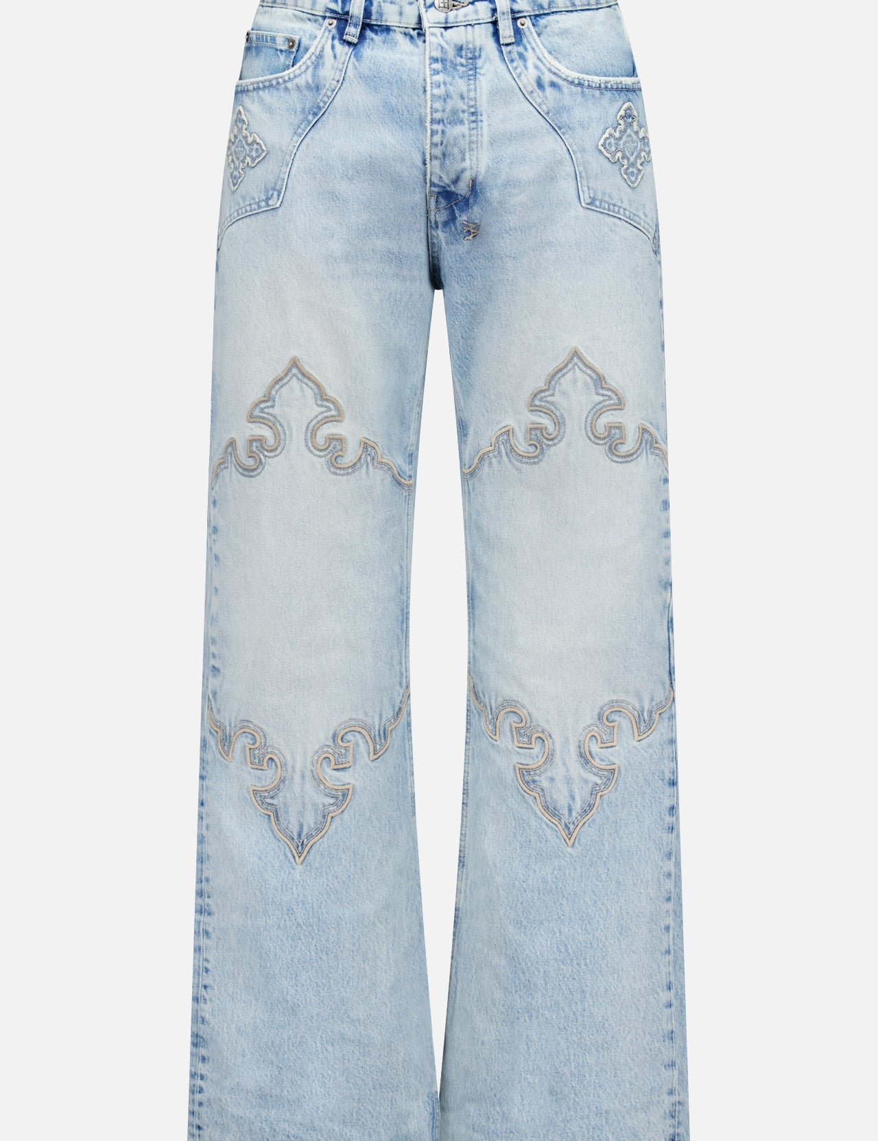 The KSUBI Toro Western Knee Paneling Jeans feature a light blue, wide-leg silhouette with decorative embroidered stitching on the front, showcasing curved designs above the knees and on the pockets for a vintage, faded look.
