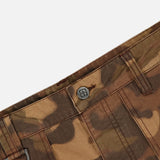 Close-up of the waistband of the KSUBI Troop Camouflage Cargo Pant, showcasing a branded button, belt loops, and a metal D-ring detail on one loop.